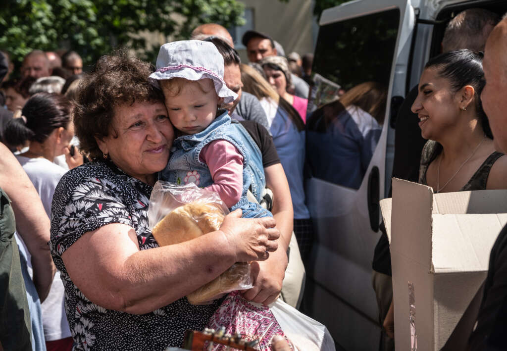 Woman with child buying bread