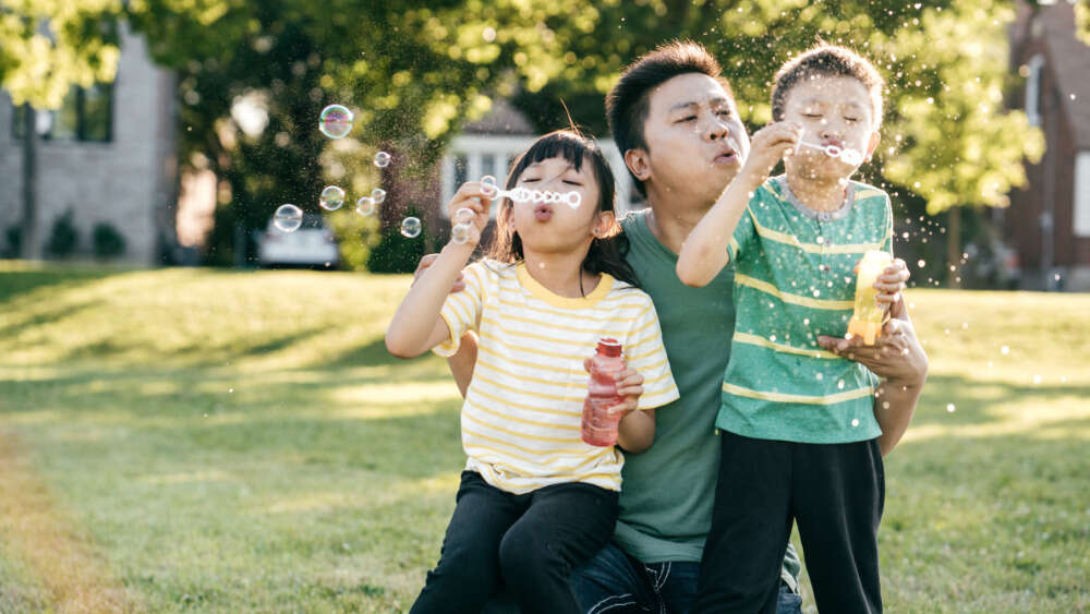 Dad and kids blowing bubbles