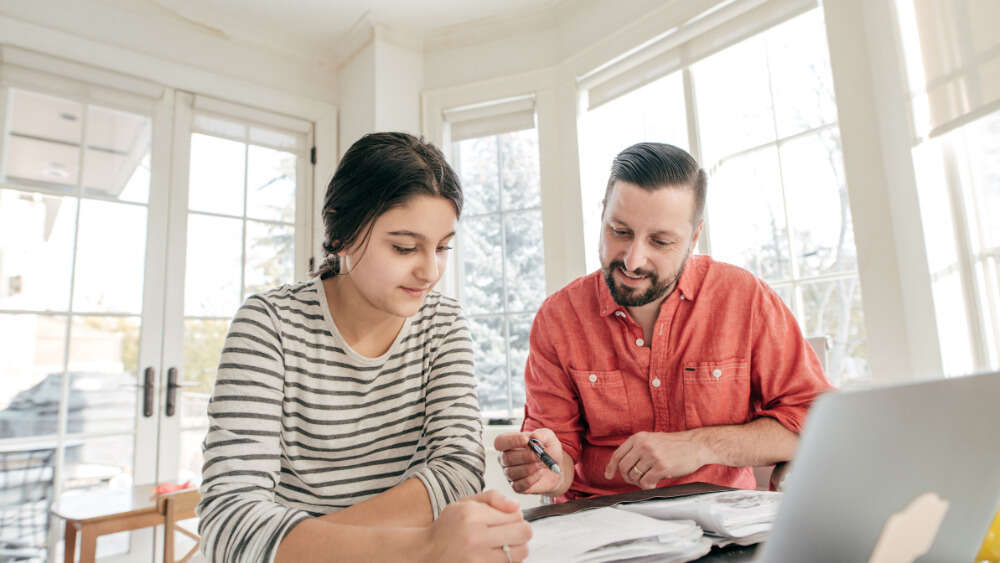 Dad helping daughter study