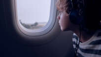 Boy looking out plane window